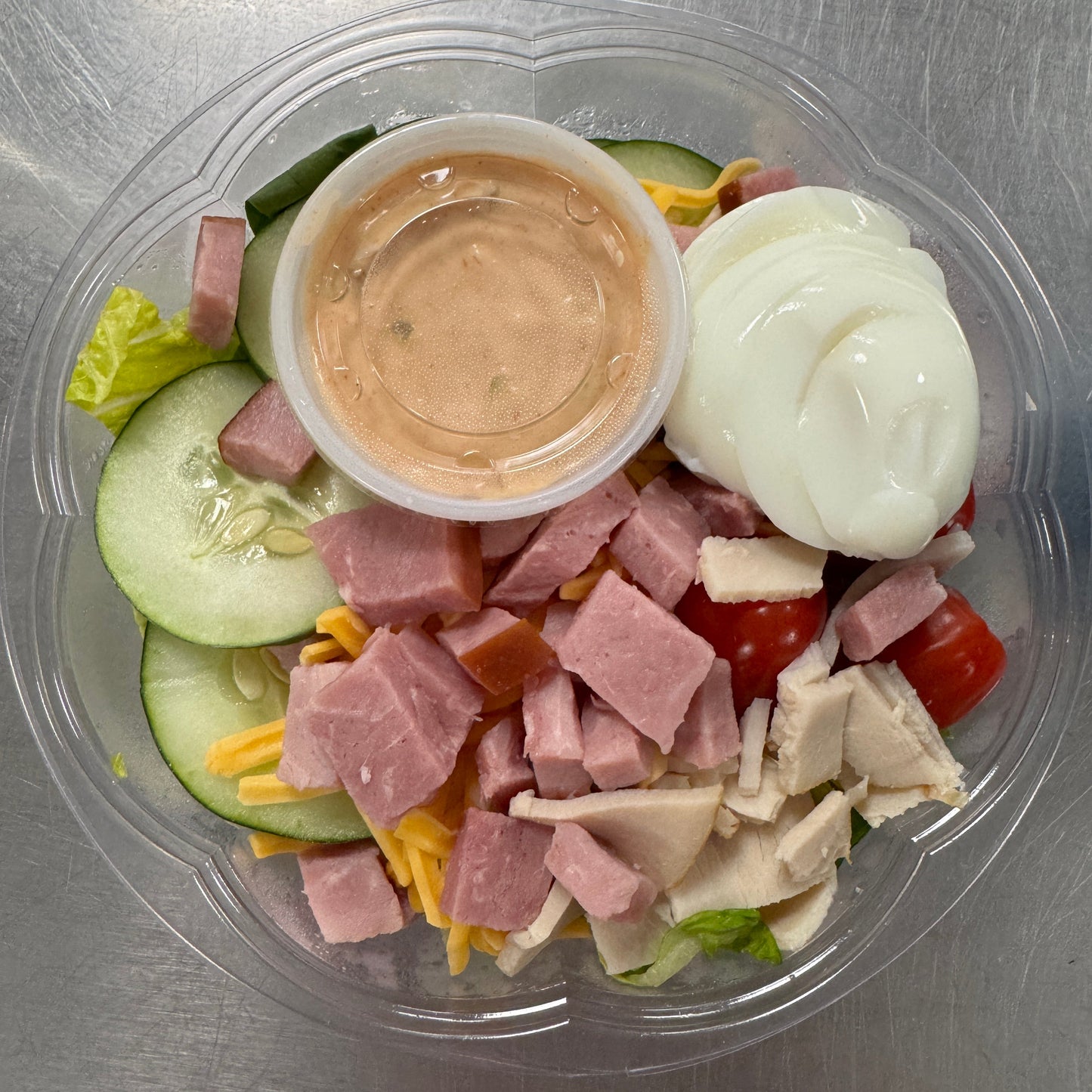 Chef Salad - greens topped with ham, turkey, cucumber, hard boiled egg, cheese, and tomatoes