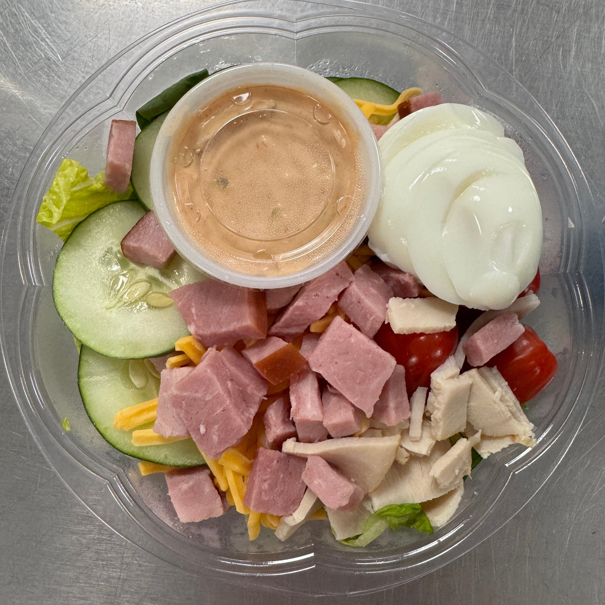 Chef Salad - greens topped with ham, turkey, cucumber, hard boiled egg, cheese, and tomatoes